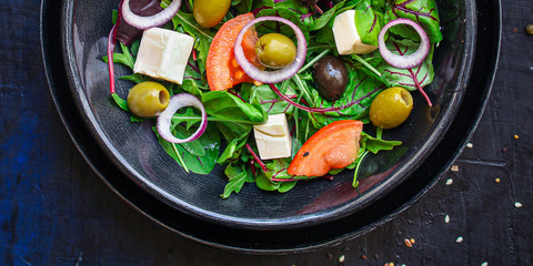 healthy salad olives, lettuce, tomato and cheese feta (greek salad, tasty vegetables snack) menu concept background. top view. copy space for text