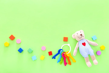 Colorful kids toys on green background. Top view, copy space