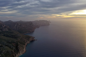 Fototapeta na wymiar The beautiful island of Mallorca Spain, photography from the air at sunset. Seascape in the evening fog.