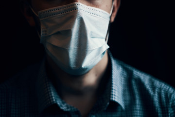 Man in mask. Protection against contagious disease, coronavirus. Dramatic view