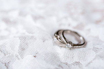 wedding ring on white fabric with soft-focus and over light in the background