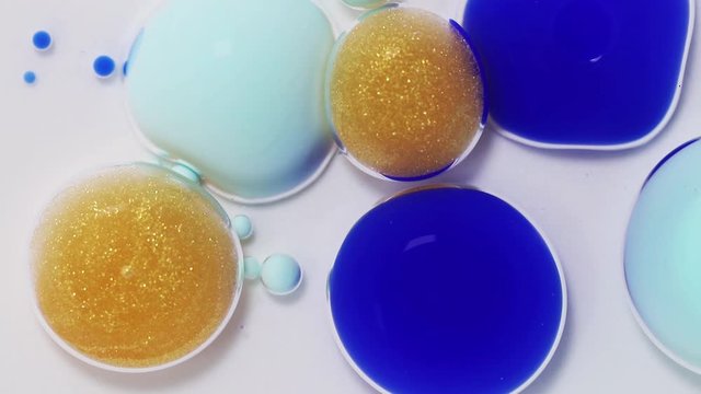 Fluid art drawing footage, trendy acryl texture with flowing effect. Liquid paint mixing artwork with waves and swirl. Detailed background motion with navy blye, golden and mint overflowing colors