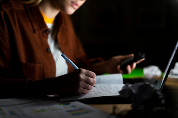 Front view of woman noting on notebook