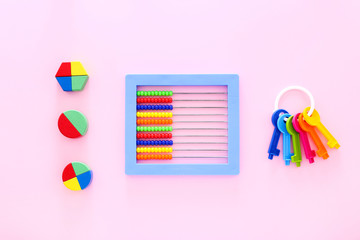 Colorful kids toys on pink background. Top view