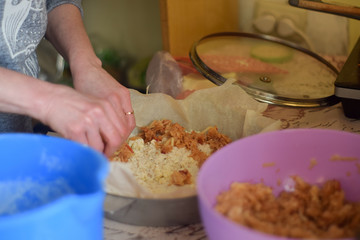 Woman cooks apple pie in the kitchen close up