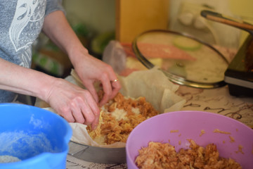 Woman cooks apple pie in the kitchen close up