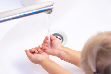 childrens hands are washed. childrens hands in foam from antibacterial soap. Protection against bacteria, coronavirus. hand hygiene. hand washing with water