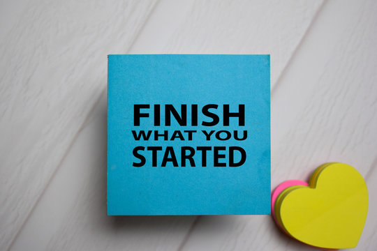 Finish What You Started write on a sticky note isolated on Office Desk.