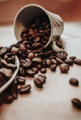 cup of coffee with beans on wooden table