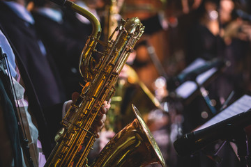 Concert view of a saxophonist, saxophone player with vocalist and musical during jazz band...