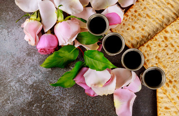Matzos of Passover celebration with matzo unleavened bread on kiddush cup of wine