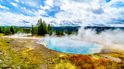 Steam coming from the turquoise waters of the Gem Pool hot spring in the Upper Geyser Basin along the Continental Divide Trail in Yellowstone National Park, Wyoming, United States