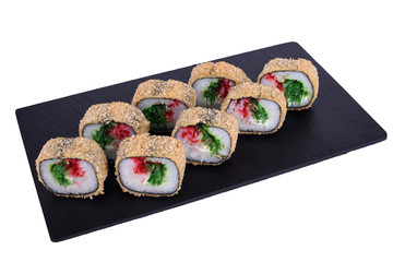 Traditional fresh japanese sushi on black stone Warm roll snow crab on a white background. Roll ingredients: surimi, philadelphia cheese, hiashi seaweed, red tobiko caviar, nori, rice, panko crackers.