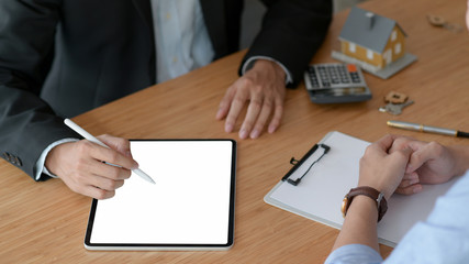 Cropped shot of Real estate insurance agents are using tablet to recommend insurance packages to customer.