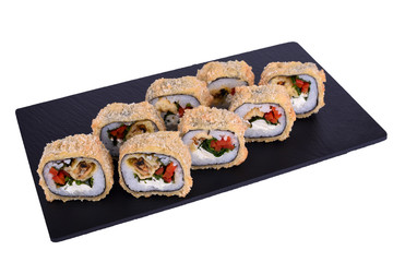 Traditional fresh japanese sushi on black stone Warm mussel roll on a white background. Roll ingredients: mussel, philadelphia cheese, bell pepper, lettuce, nori, rice, panko crackers.