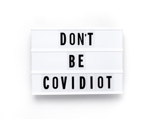 Sign - DON'T BE COVIDIOT on light box, Covidiot is new name for shaming ignorant coronavirus reactions