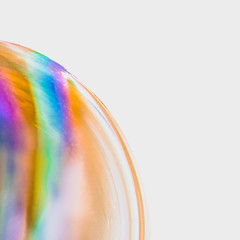 Huge soap bubble with colourful pattern against white background