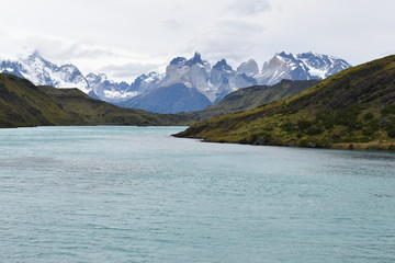 Obraz premium Snow covered mountains with the light blue ocean in front in Torres del Paine National Park in Chile, Patagonia