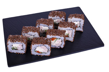 Traditional fresh japanese sushi rolls on black stone Maguro on a white background. Roll ingredients: ham, philadelphia cheese, tomato, cucumber, flax, nori, rice.