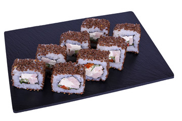 Traditional fresh japanese sushi rolls on black stone Maguro on a white background. Roll ingredients: ham, philadelphia cheese, tomato, cucumber, flax, nori, rice.