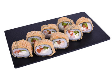 Traditional fresh japanese sushi on black stone Warm roll caesar on a white background. Roll ingredients: smoked chicken fillet, philadelphia cheese, tomato, lettuce, nori, rice, panko crackers.
