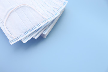 Clean blue face Masks  isolated on light blue blackground   against  protection infection  safe from coronavirus COVID-19 prevention of the spread of virus and pandemic