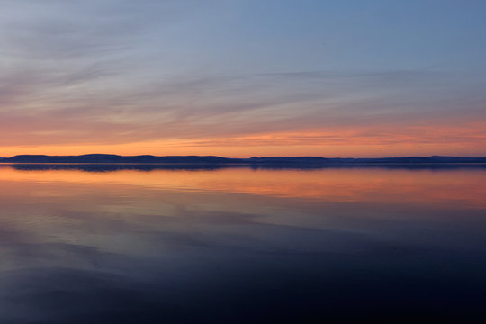 reflecting water distant hills at sunset at lake Balaton, Hungary