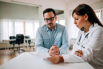 Handsome man listening to a doctor.