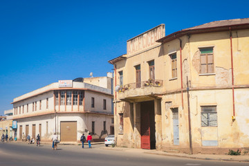 Fototapeta na wymiar Asmara, Eritrea - November 01, 2019: Old Buildings and Cars around of Local Market