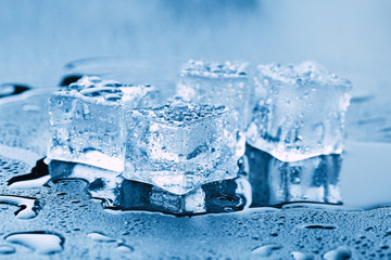 Pyramid of beautiful thawed ice cubes with drops of water