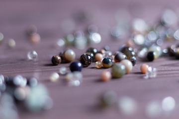 colorful natural stone gem beads on brown wooden  background