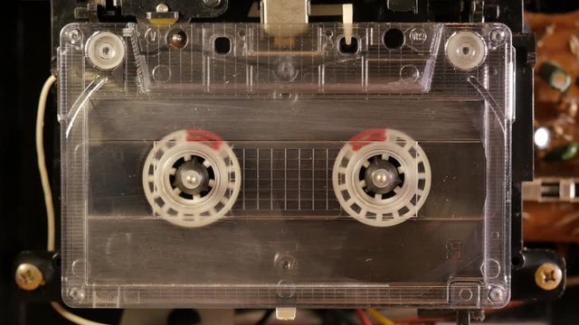 Cassette Tape playing in open tape recorder
