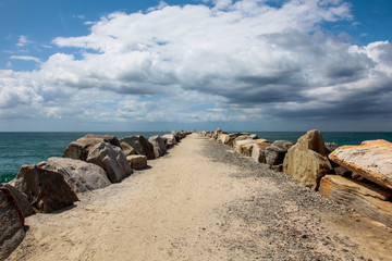Fototapeta na wymiar Pier rocks on the beach