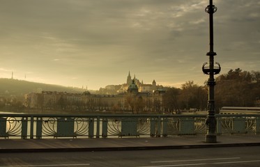 Obraz premium Panoramic view of Prague from a bridge with an asphalted street and a sidewalk with a lamppost (Prague, Czech Republic, Europe)