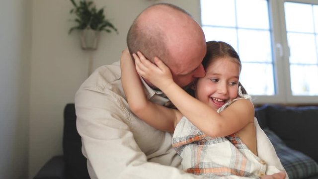 Father consoling his daughter at home
