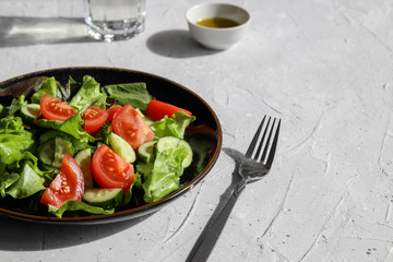 Summer fresh detox salad and water glass. Healthy diet food concept