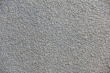 Stone chip rough textured wall painted grey
