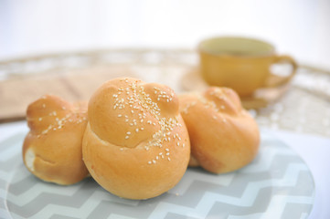 Bread loaf, fresh bun on cutting board. Brioche bread on breakfast.