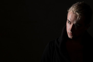  Man portrait blond hair on a black background. Beautiful, elegant, advertising, brutal, glamor
