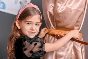 Cute little dressmaker working in atelier