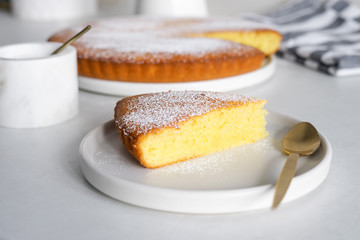 Slice of homemade sweet semolina cake on a white plate