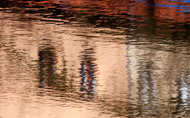 Reflection of a building on a corrugated water surface