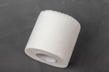 One toilet paper rolls on a gray background