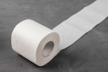 One toilet paper rolls on a gray background