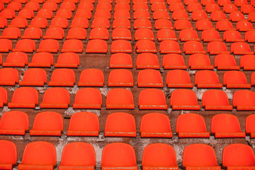 Naklejka premium a bunch of orange bleachers without a single seat.