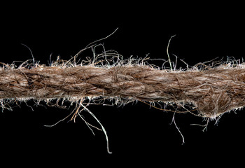 Fototapeta premium Twisted manila rope isolated on black