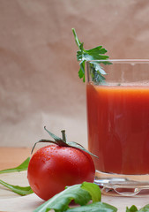 Red tomato on a chopping Board with Basil leaves on a wooden background. Space for copying. Fresh tomato for cooking. Tomato with water drops,
