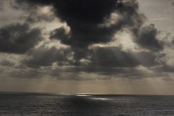 god rays rainy season ocean dark clouds