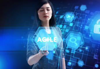 Business, Technology, Internet and network concept. Young businessman working on a virtual screen of the future and sees the inscription: Agile