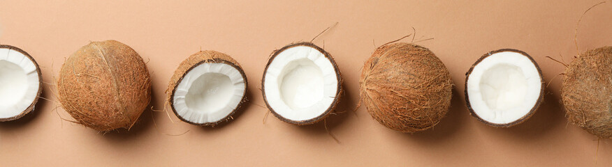 Flat lay with coconut on brown background, space for text - obrazy, fototapety, plakaty